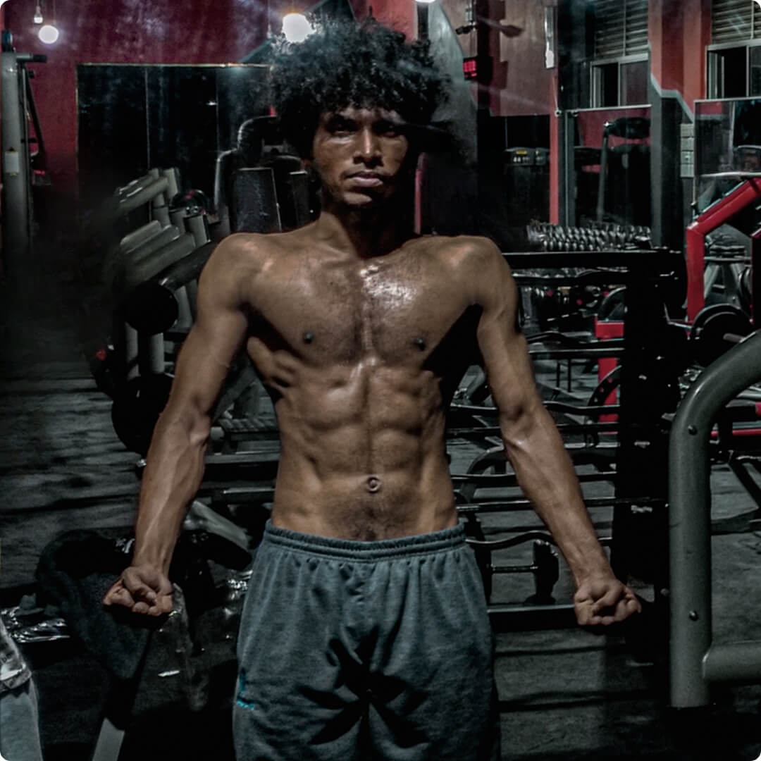 a shredded man in a gym posing for a photo Mobile