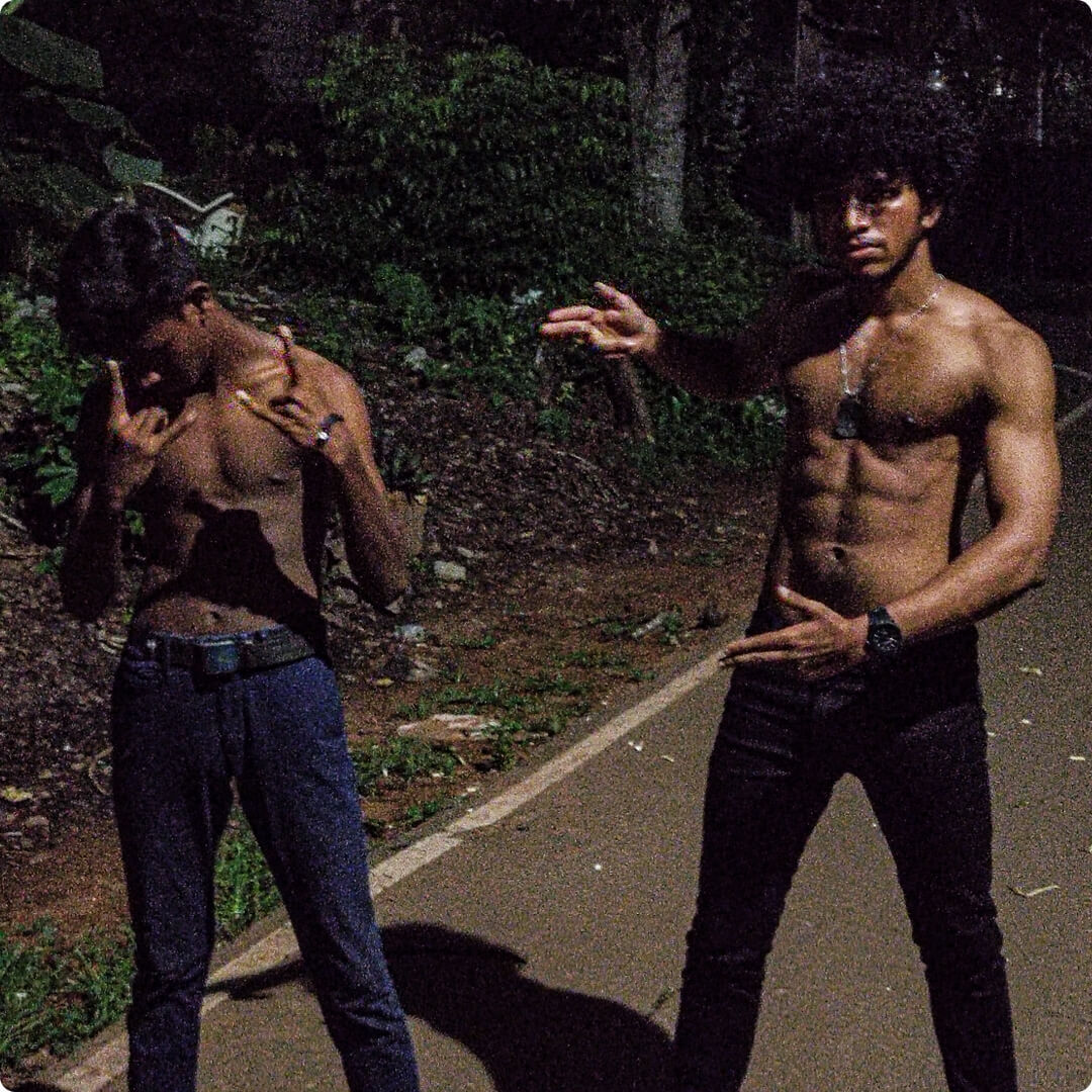 two bodybuilders standing on the side of a road posing for a picture Mobile